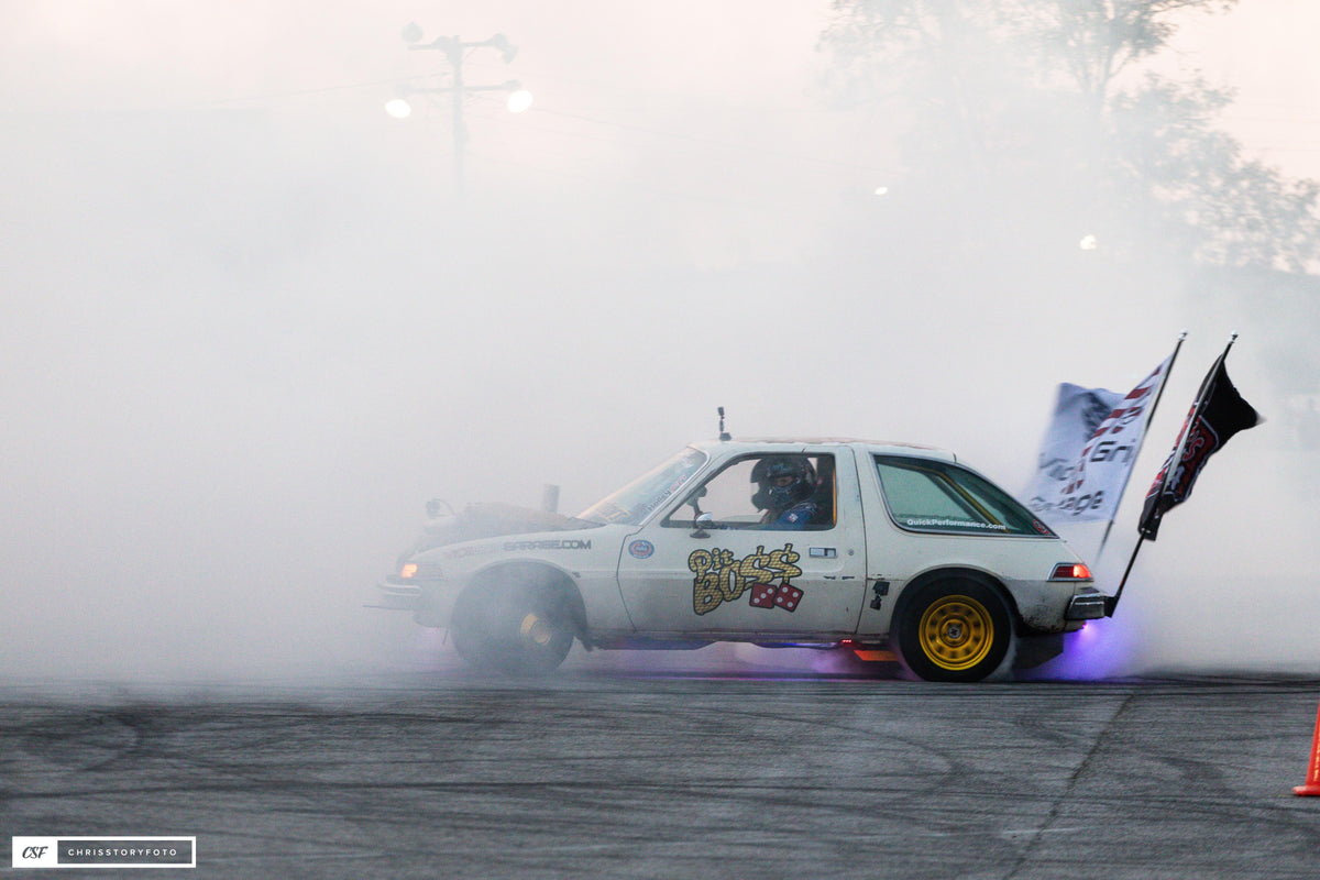 Side view of Pit Boss AMC Pacer in heavy tire smoke with purple underglow