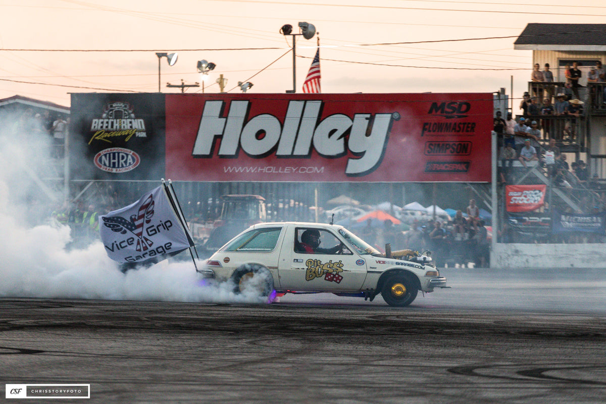 Pit Boss AMC Pacer laying down tire smoke in front of a Holley banner