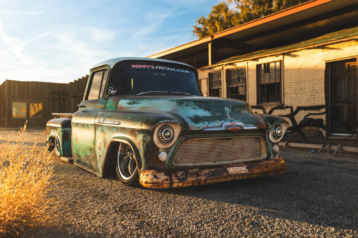 Turquoise patina 1957 Chevrolet pickup with a sealed, clear-coated finish at golden hour